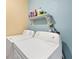 Laundry room with a side-by-side washer and dryer, with a shelf with cleaning supplies at 13559 Martha Ave, Port Charlotte, FL 33981