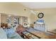 Open-concept living room with vaulted ceiling, ceiling fan, and easy access to dining and porch at 13559 Martha Ave, Port Charlotte, FL 33981