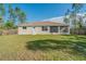 A cozy backyard featuring a well-maintained lawn, privacy fence, and screened-in porch at 14795 San Domingo Blvd, Port Charlotte, FL 33981
