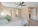 Spacious bedroom includes a ceiling fan, ensuite bathroom, and walk-in closet at 14795 San Domingo Blvd, Port Charlotte, FL 33981