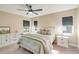 Cozy bedroom with neutral tones, two windows, bedside tables, and carpet flooring at 14795 San Domingo Blvd, Port Charlotte, FL 33981
