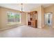 Cozy dining area offering natural light from a large window and a classic china cabinet at 14795 San Domingo Blvd, Port Charlotte, FL 33981