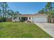 Inviting single-Gathering home with a well-kept lawn, screened entryway, and convenient two-car garage at 14795 San Domingo Blvd, Port Charlotte, FL 33981