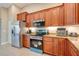 Spacious kitchen with wooden cabinets, granite countertops, and stainless steel refrigerator and stove at 14795 San Domingo Blvd, Port Charlotte, FL 33981