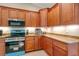 Well-lit kitchen features wooden cabinets, granite countertops, and stainless steel appliances at 14795 San Domingo Blvd, Port Charlotte, FL 33981