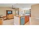 Open concept kitchen with granite counters, tile floors, stainless appliances and breakfast bar seating at 14795 San Domingo Blvd, Port Charlotte, FL 33981