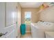 Functional laundry room with washer, dryer, storage shelves, and a window providing natural light at 14795 San Domingo Blvd, Port Charlotte, FL 33981