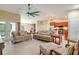 Open concept living room featuring tile floors, neutral paint, ceiling fan and views to the kitchen and dining room at 14795 San Domingo Blvd, Port Charlotte, FL 33981