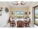 Dining area with a glass table, seating for six, and scenic waterfront view at 15180 Alsask Cir, Port Charlotte, FL 33981