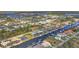 Expansive aerial view of a waterfront community showcasing canals, homes, and lush greenery at 15776 Melport Cir, Port Charlotte, FL 33981