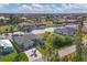 Aerial view of a home with a boat dock, and lush landscaping along a waterfront canal at 15776 Melport Cir, Port Charlotte, FL 33981