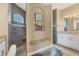 Elegant bathroom features stone shower with bench seating, a granite vanity and a decorative shelf at 15776 Melport Cir, Port Charlotte, FL 33981