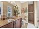 This bathroom has dark wood cabinets with granite counters and a tiled walk-in shower with a towel rack at 15776 Melport Cir, Port Charlotte, FL 33981