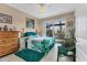 This comfortable bedroom has neutral walls, a ceiling fan, and a sliding glass door to the outside at 15776 Melport Cir, Port Charlotte, FL 33981