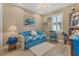 Bright bedroom with coastal decor features a daybed, white shutters, and light wood floors at 15776 Melport Cir, Port Charlotte, FL 33981