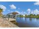 A canal view featuring a dock with boat lift at 15776 Melport Cir, Port Charlotte, FL 33981
