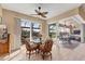 Cozy dining area with natural light, complemented by stylish wicker chairs and a seamless transition to the outdoor space at 15776 Melport Cir, Port Charlotte, FL 33981