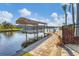 Private boat dock and lift on a canal, providing easy access to waterfront activities at 15776 Melport Cir, Port Charlotte, FL 33981