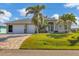 Beautiful single Gathering home with a well-manicured lawn, mature trees and a three-car garage at 15776 Melport Cir, Port Charlotte, FL 33981