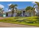 Beautiful single Gathering home with a well-manicured lawn, mature trees and a three-car garage at 15776 Melport Cir, Port Charlotte, FL 33981