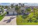 Beautiful single Gathering home with a well-manicured lawn, brick driveway, and three-car garage at 15776 Melport Cir, Port Charlotte, FL 33981