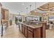 Expansive kitchen area with stainless steel appliances, wood cabinetry, granite counters, and seamless transition to living spaces at 15776 Melport Cir, Port Charlotte, FL 33981