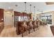 Bright kitchen featuring stainless steel appliances, wood cabinetry, granite countertops, and a breakfast bar overlooking the dining area at 15776 Melport Cir, Port Charlotte, FL 33981