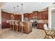 Spacious kitchen boasts stainless steel appliances, wood cabinets, granite countertops, and a cozy breakfast bar at 15776 Melport Cir, Port Charlotte, FL 33981