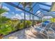 Outdoor lanai area with patio furniture and views of the canal at 15776 Melport Cir, Port Charlotte, FL 33981