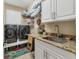 This clean laundry room features granite countertops, new appliances, and white cabinets at 15776 Melport Cir, Port Charlotte, FL 33981