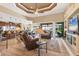 Open concept living room with wood floors, entertainment center and view of the pool and backyard at 15776 Melport Cir, Port Charlotte, FL 33981