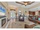 Open concept living room featuring wood floors, a fireplace, comfortable furniture, and abundant natural light at 15776 Melport Cir, Port Charlotte, FL 33981