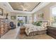 Serene main bedroom with a trey ceiling, natural light, and a sitting area with seamless outdoor access at 15776 Melport Cir, Port Charlotte, FL 33981