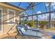 Enclosed patio area with outdoor shower and lounge chairs facing the water at 15776 Melport Cir, Port Charlotte, FL 33981