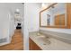 Bathroom featuring neutral tile floors, wooden vanity, and access to hallway at 18 Pebble Beach Road, Rotonda West, FL 33947