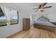 Bright bedroom features wood floors, neutral paint, and a tufted headboard at 18 Pebble Beach Road, Rotonda West, FL 33947