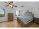 Bright bedroom features wood floors, neutral paint, and a tufted headboard at 18 Pebble Beach Road, Rotonda West, FL 33947