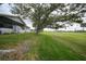 Charming home with a well-kept lawn and mature trees offering a serene and inviting outdoor space at 18 Pebble Beach Road, Rotonda West, FL 33947