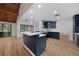 Modern kitchen featuring an island, stainless steel appliances, and updated cabinets at 18 Pebble Beach Road, Rotonda West, FL 33947