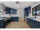 Modern kitchen boasting stainless steel appliances, beautiful white countertops and navy blue cabinetry at 18 Pebble Beach Road, Rotonda West, FL 33947