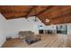 Spacious living room featuring wood plank floors, a vaulted ceiling, and natural light at 18 Pebble Beach Road, Rotonda West, FL 33947
