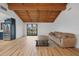 Open-concept living space with hardwood floors, beamed ceiling, and a slider door at 18 Pebble Beach Road, Rotonda West, FL 33947
