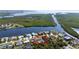 Aerial view of home featuring fenced in back yard with pool and adjacent canal at 18970 Mcgrath Cir, Port Charlotte, FL 33948