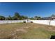 Large backyard features a storage shed, garden and mature landscaping, enclosed by a white privacy fence at 18970 Mcgrath Cir, Port Charlotte, FL 33948