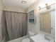 Well-lit bathroom with a shower-tub combo, decorative vanity, and classic design elements at 18970 Mcgrath Cir, Port Charlotte, FL 33948