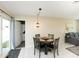 Dining area with a table and chairs, and sliding glass doors leading to the backyard at 18970 Mcgrath Cir, Port Charlotte, FL 33948