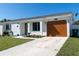 Charming single-story home with manicured lawn, lovely flower bed, and attached garage at 18970 Mcgrath Cir, Port Charlotte, FL 33948