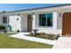 Charming single-story home with manicured lawn, lovely flower bed, and attached garage at 18970 Mcgrath Cir, Port Charlotte, FL 33948