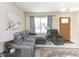Bright living room with a comfortable sectional sofa, accent pillows, and natural light from a large window at 18970 Mcgrath Cir, Port Charlotte, FL 33948
