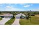 An aerial view showcasing a single-Gathering home with a two-car garage and lush green lawn at 194 Sunset Rd, Rotonda West, FL 33947